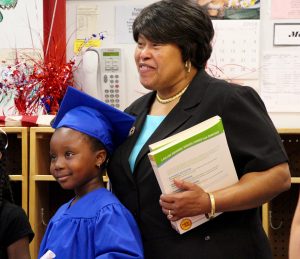 Guardian Angel Teacher Laytina James with a pre-school graduate.