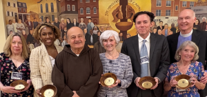 Our 2026 Caring Bowl honorees, shown from left with Brother Ronald, are longtime supporter and Guild Member Robin Richman; Beautiful Gate Outreach Director Shirlene Webster; longtime supporter and Emmanuel Dining Room Breakfast Volunteer Elvira Kipp; supporter and volunteer supporter and adviser Dan Miller, and the Reverend Dr. Gregory Knox Jones, pastor, and Camilla Jones of Westminster Presbyterian Church.